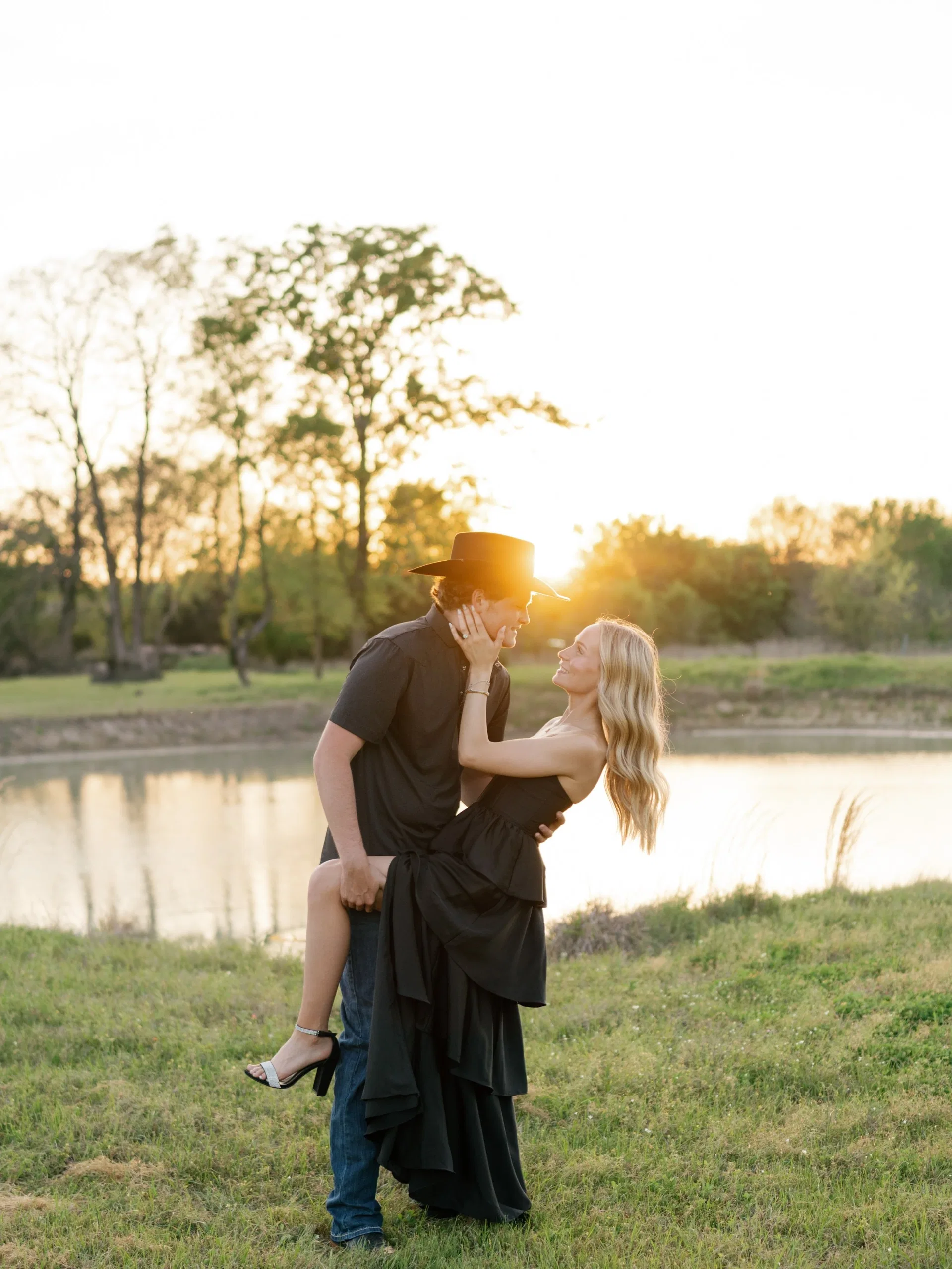 Dramatic sunset dip, her heel lifted, his cowboy hat silhouetted against the Texas sky